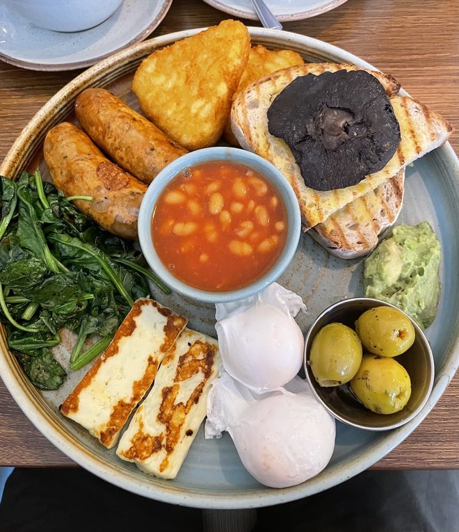 Overhead veggie breakfast plate with halloumi, avocado and poached eggs